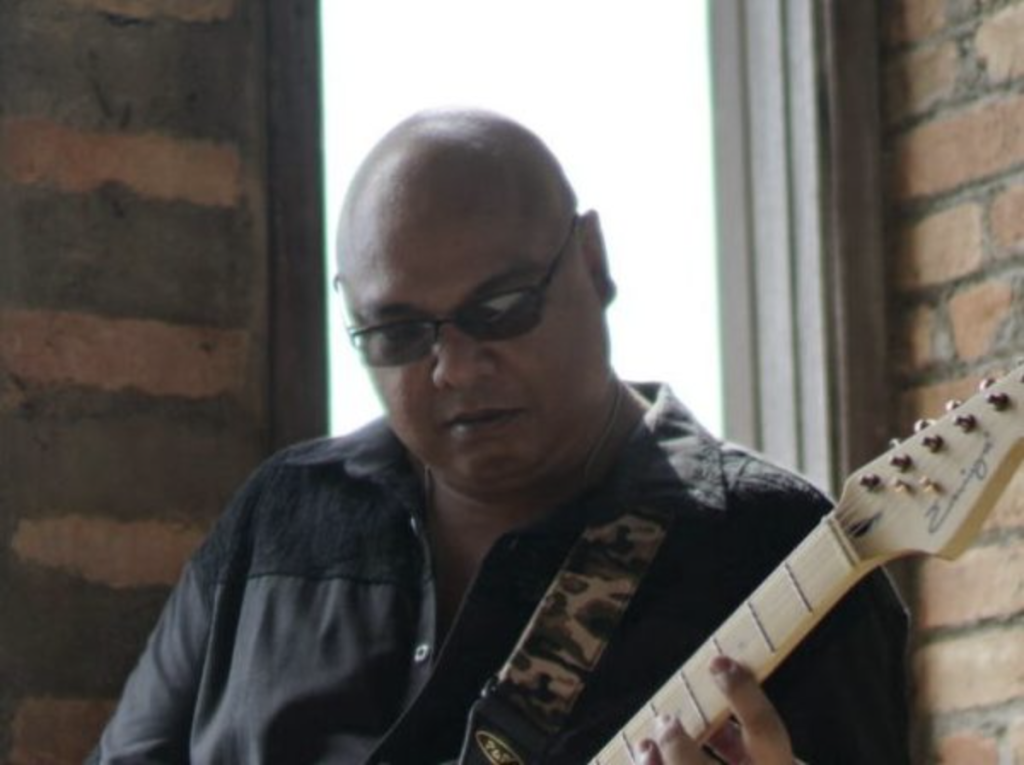 Paul Danial playing guitar